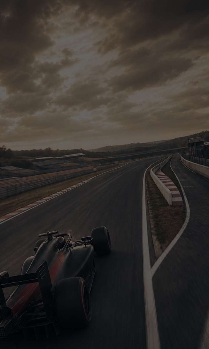 An open-wheel car on a sweeping section of circuit