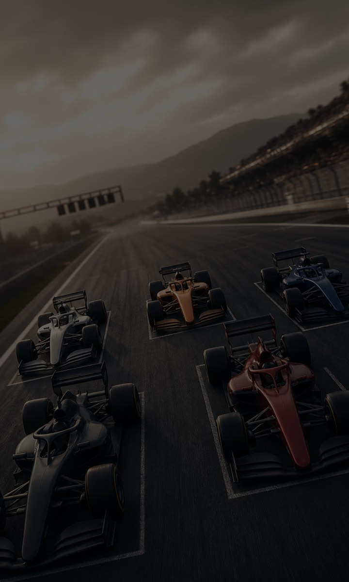 Five racing cars line up on the starting grid